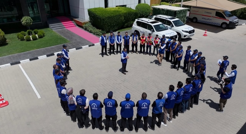 Rwanga volunteers briefed in a circle before a campaign